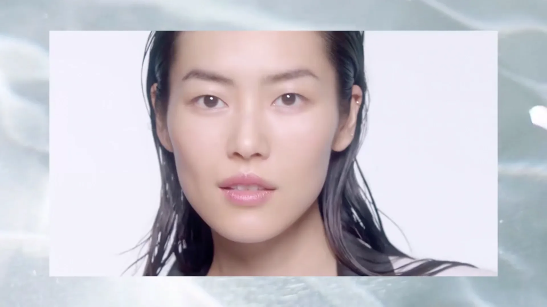 Chanel Hydra Beauty still of Asian model with wet hair staring into camera with graphic frame