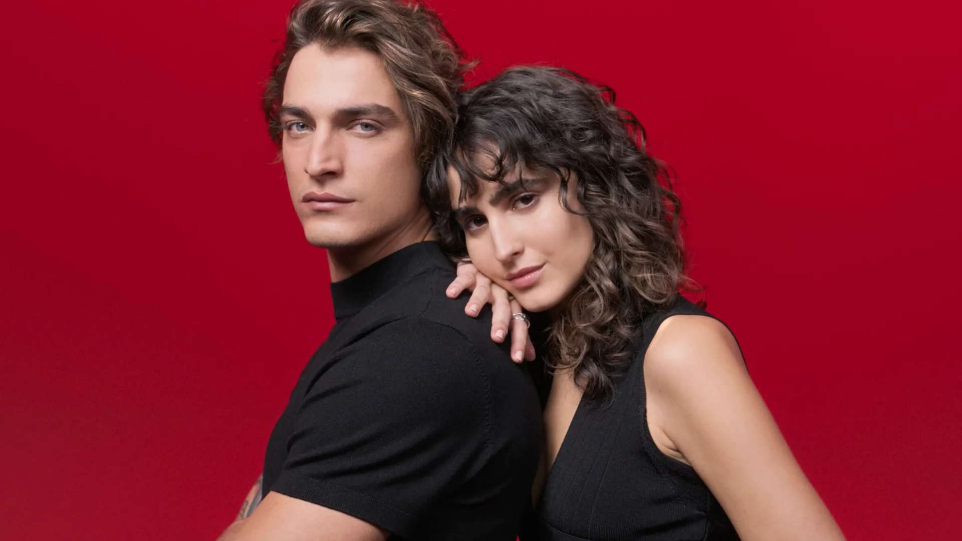 Dercos Anti Hair Loss commercial still of male and female mode staring into camera in a red world directed by Barnaby Roper
