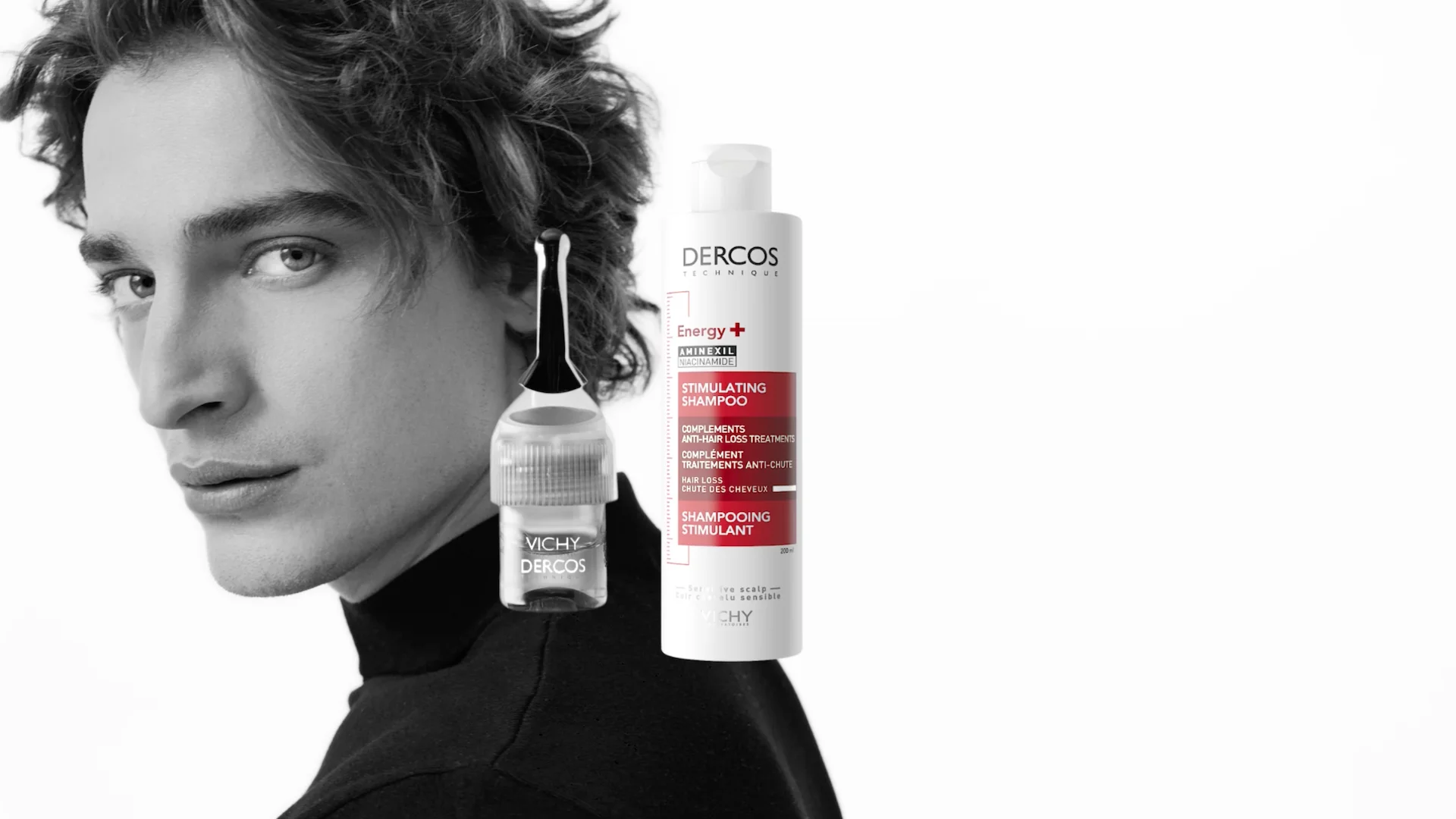 male model in black and white staring into camera with Dercos Anti Hairloss packs floating in middle of the frame