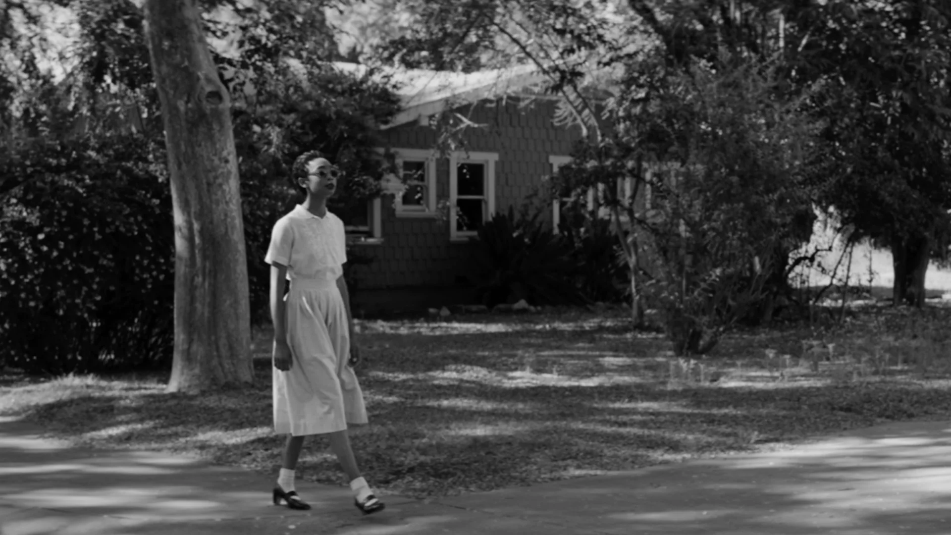 Elizabeth Eckford walking in The First Day short film Nowness black and white still directed by Barnaby Roper