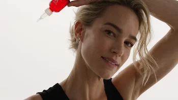 Vichy B3 Commercial still of Blonde woman holding Vichy B3 serum pack by Director Barnaby Roper